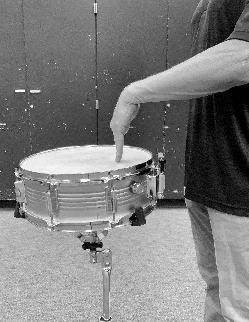 Finger on snare head